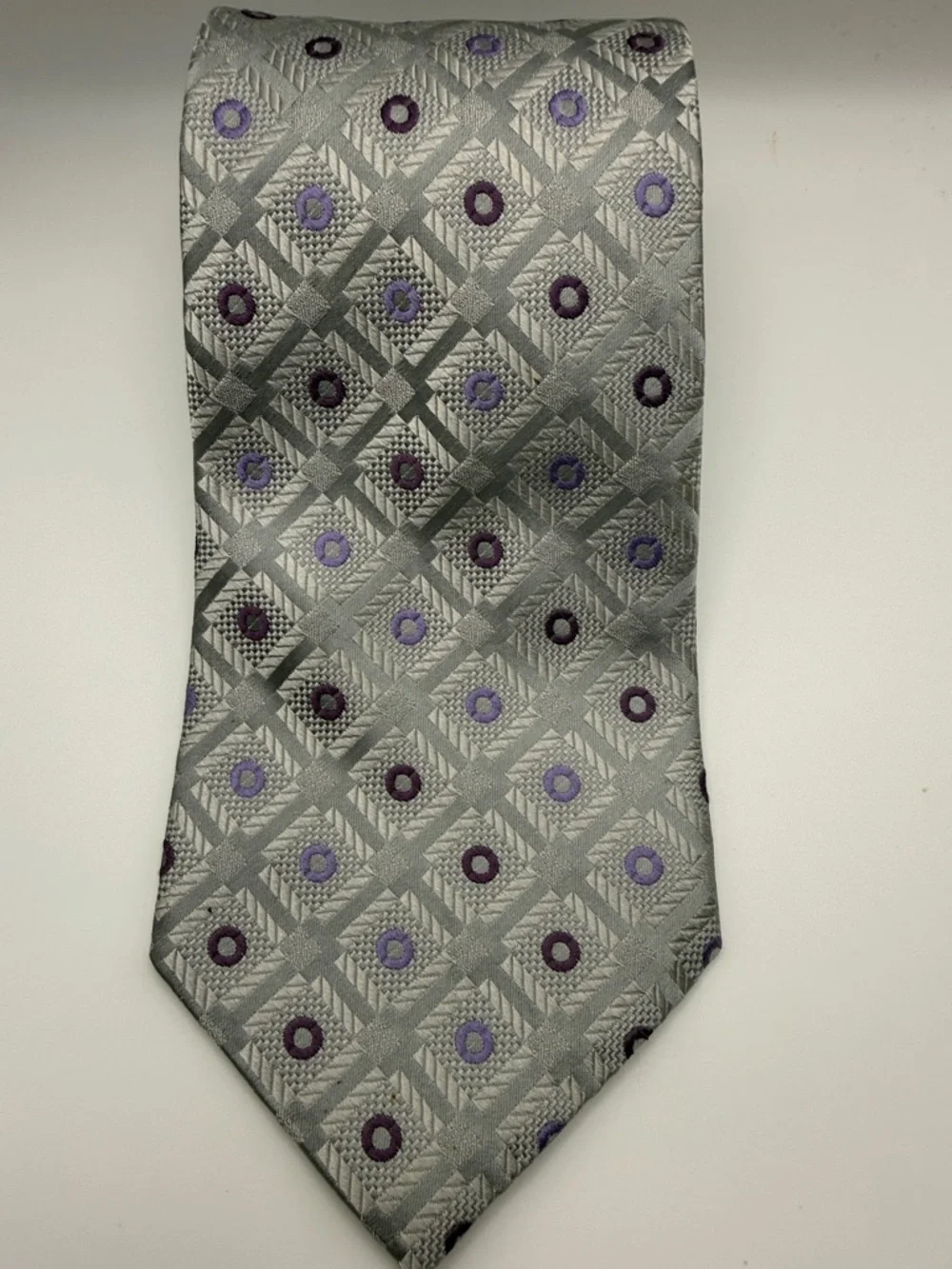 Pierre Cardin tie in a silver and purple geometric pattern. 100% silk.